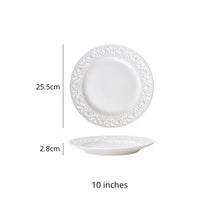 Load image into Gallery viewer, Juliette White Lace Dinnerware by Allthingscurated adds an elegant touch to your tabletop. This sophisticated set is crafted out of ceramic with a beautiful embossed lace rim, giving it a vintage touch. The creamy white pieces come in a dinner plate and cake stand in 2 sizes for easy mixing and matching. They are perfectly sized for a main course, starters and desserts. Featured here is a 10 inches or 25.5cm plate.