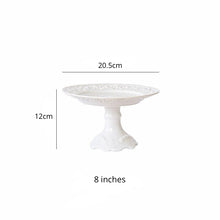 Load image into Gallery viewer, Juliette White Lace Dinnerware by Allthingscurated adds an elegant touch to your tabletop. This sophisticated set is crafted out of ceramic with a beautiful embossed lace rim, giving it a vintage touch. The creamy white pieces come in a dinner plate and cake stand in 2 sizes for easy mixing and matching. They are perfectly sized for a main course, starters and desserts. Featured here is an 8 inches or 20.5cm cake stand with a 12cm or 4.7 inches height.