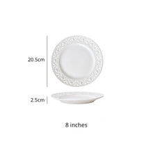 Load image into Gallery viewer, Juliette White Lace Dinnerware by Allthingscurated adds an elegant touch to your tabletop. This sophisticated set is crafted out of ceramic with a beautiful embossed lace rim, giving it a vintage touch. The creamy white pieces come in a dinner plate and cake stand in 2 sizes for easy mixing and matching. They are perfectly sized for a main course, starters and desserts. Featured here is an 8 inches or 20.5cm plate.