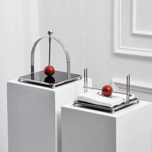 Load image into Gallery viewer, AXO Stainless Steel Paper Napkin/Serviette Holders by Allthingscurated feature a stunning range holders in a minimalist design with weighted orb in red and black, ensuring your paper napkins stay perfectly in place. Elevate your dining experience with these functional holders that are perfect for buffet tables and outdoor dining.