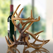 Load image into Gallery viewer, Antler Wine Bottle Holder by Allthingscurated is hand-crafted from resin and hand-painted to emulate the look of genuine antlers. Beautiful and sculptural, it’s a great gift for any occasion as well as a perfect addition to give your winter tablescape a cabin vibe. On its own, it’s a decorative, ornamental piece that gives a luxurious look to your mantel, tabletop or shelf. Measuring approximately 33cm or 13 inches in height, 35cm or 13.7 inches wide and a depth of 23cm or 9 inches.