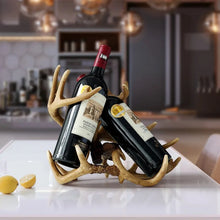 Load image into Gallery viewer, Antler Wine Bottle Holder by Allthingscurated is hand-crafted from resin and hand-painted to emulate the look of genuine antlers. Beautiful and sculptural, it’s a great gift for any occasion as well as a perfect addition to give your winter tablescape a cabin vibe. On its own, it’s a decorative, ornamental piece that gives a luxurious look to your mantel, tabletop or shelf. Measuring approximately 33cm or 13 inches in height, 35cm or 13.7 inches wide and a depth of 23cm or 9 inches.