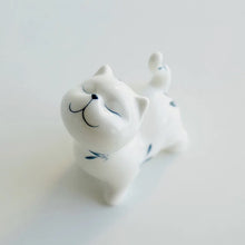 Load image into Gallery viewer, Petite Butterfly Orchid Porcelain by Allthingscurated is handmade with exquisite craftsmanship. Featuring beautiful, hand-painted blue butterfly orchids on white porcelain, the dainty design exudes an elegant charm and a touch of playfulness with its naughty and oh-so-cute expression. Small yet exquisite, it will charm any cat lovers and bring joy to any room.
