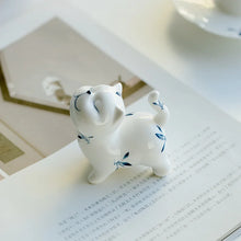 Load image into Gallery viewer, Petite Butterfly Orchid Porcelain by Allthingscurated is handmade with exquisite craftsmanship. Featuring beautiful, hand-painted blue butterfly orchids on white porcelain, the dainty design exudes an elegant charm and a touch of playfulness with its naughty and oh-so-cute expression. Small yet exquisite, it will charm any cat lovers and bring joy to any room.