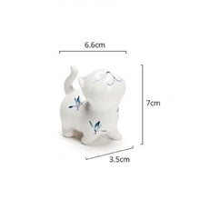Load image into Gallery viewer, Petite Butterfly Orchid Porcelain by Allthingscurated is handmade with exquisite craftsmanship. Featuring beautiful, hand-painted blue butterfly orchids on white porcelain, the dainty design exudes an elegant charm and a touch of playfulness with its naughty and oh-so-cute expression. Small yet exquisite, it will charm any cat lovers and bring joy to any room.