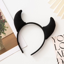 Load image into Gallery viewer, Horn Shape Headband by Allthingscurated features trendy, three-dimensional horns that is fun and perfect for elevating your Halloween party look. This accessory is perfect for adding a playful touch to your costume and make a statement at any Halloween party. Comes in 3 colors. Featured here is the black headband.