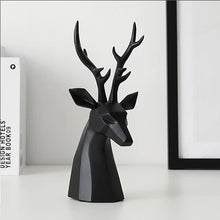 Load image into Gallery viewer, This beautiful Deer Head Bust sculpture is made of resin and comes available in 4 colors of black, white, gray and teal. Measuring 26cm or 10 inches in height and 11.5cm or 4.5 inches in width. This figurine spots a contemporary design with sculptural form inspired by Origami. This decorative piece will add timeless elegance to your space year-round. Perfect for festive tablescapes, mantels and shelves. This is a deer head bust in Black.