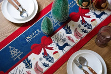 Load image into Gallery viewer, Holiday Bow and Elk Table Runners by Allthingscurated are inspired by all the notable symbols of Christmas like the merry bow, Christmas tree, elk and snowflakes. The jacquard table runners come in vibrant hues of blue and green with beautiful embroidery and complete with pretty tassels. Available in 9 sizes. They are perfect holiday decoration to bring a festive touch to. Your table setting.