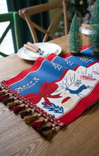 Load image into Gallery viewer, Holiday Bow and Elk Table Runners by Allthingscurated are inspired by all the notable symbols of Christmas like the merry bow, Christmas tree, elk and snowflakes. The jacquard table runners come in vibrant hues of blue and green with beautiful embroidery and complete with pretty tassels. Available in 9 sizes. They are perfect holiday decoration to bring a festive touch to. Your table setting.
