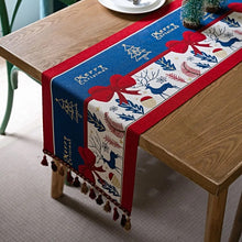 Load image into Gallery viewer, Holiday Bow and Elk Table Runners by Allthingscurated are inspired by all the notable symbols of Christmas like the merry bow, Christmas tree, elk and snowflakes. The jacquard table runners come in vibrant hues of blue and green with beautiful embroidery and complete with pretty tassels. Available in 9 sizes. They are perfect holiday decoration to bring a festive touch to. Your table setting.