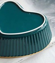 Load image into Gallery viewer, Teal ceramic heart-shaped dish on a light background. Gold-rimmed Heart Shape Ceramic Bowl by Allthingscurated is a beautiful and versatile piece to own in your dinnerware collection. Perfect for salads, desserts and appetizers, its charming design adds an extra touch of romance for Valentine’s Day dinner; and make everyday meals extra special.