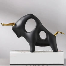Load image into Gallery viewer, Brooklyn Bull Sculptures by Allthingscurated capture the elegance and dramatic aura of the auspicious animal in a sleek, modern design with matte black finish and gold-accented horns. A visually-appealing and timeless collection, it’s a fashionable piece to add to any contemporary home and spaces. And perfect as a gift for those with a Taurus horoscope or Chinese Ox zodiac sign. Featured here is the Charging Bull Sculpture.