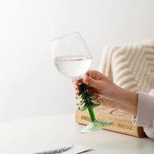 Load image into Gallery viewer, These charming Christmas Tree Stem Glass by Allthingscurated features a sculptural 3D design on the stem. Comes in classic green or bright white, it adds a festive vibe to your holiday gatherings. These glasses make thoughtful gifts for your loved ones. Featured here is the stem glass in green tree design.