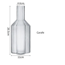 Load image into Gallery viewer, Florentina Drinkware by Allthingscurated embraces a modern design featuring sleek fluted lines with a unique shape reminiscent of a peach blossom flower. Stylish and chic, this collection includes a carafe, goblets and several tumblers, including a glamorous coupe cocktail glass. Add elegance to everyday use with this beautiful collection and just as perfect for setting an extravagant holiday table. Seen here is a Carafe.