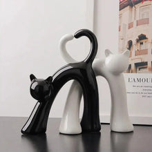 Load image into Gallery viewer, These Cat Couple Love Figurines by Allthingscurated are perfect for cat lovers. Made of ceramic, they feature a pair of cute and whimsical cats in contrasting colors, with their tails entwined to form a heart shape. A romantic and unique gift for any occasion.