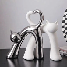 Load image into Gallery viewer, These Cat Couple Love Figurines by Allthingscurated are perfect for cat lovers. Made of ceramic, they feature a pair of cute and whimsical cats in contrasting colors, with their tails entwined to form a heart shape. A romantic and unique gift for any occasion.
