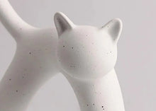 Load image into Gallery viewer, These Cat Couple Love Figurines by Allthingscurated are perfect for cat lovers. Made of ceramic, they feature a pair of cute and whimsical cats in contrasting colors, with their tails entwined to form a heart shape. A romantic and unique gift for any occasion.