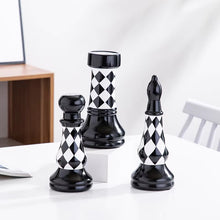 Load image into Gallery viewer, Checkered 6-piece Chess Set by Allthingscurated is both elegant and delightfully unique. Designed with a striking, graphic pattern in black and white, it adds a touch of sophistication to any space, whether your home décor style is modern or traditional. Made of porcelain, this decorative set is an ideal gift for any chess lovers.