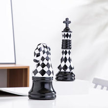 Load image into Gallery viewer, Checkered 6-piece Chess Set by Allthingscurated is both elegant and delightfully unique. Designed with a striking, graphic pattern in black and white, it adds a touch of sophistication to any space, whether your home décor style is modern or traditional. Made of porcelain, this decorative set is an ideal gift for any chess lovers.