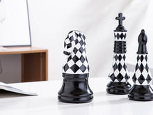 Load image into Gallery viewer, Checkered 6-piece Chess Set by Allthingscurated is both elegant and delightfully unique. Designed with a striking, graphic pattern in black and white, it adds a touch of sophistication to any space, whether your home décor style is modern or traditional. Made of porcelain, this decorative set is an ideal gift for any chess lovers.
