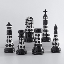 Load image into Gallery viewer, Checkered 6-piece Chess Set by Allthingscurated is both elegant and delightfully unique. Designed with a striking, graphic pattern in black and white, it adds a touch of sophistication to any space, whether your home décor style is modern or traditional. Made of porcelain, this decorative set is an ideal gift for any chess lovers.