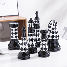 Load image into Gallery viewer, Checkered 6-piece Chess Set by Allthingscurated is both elegant and delightfully unique. Designed with a striking, graphic pattern in black and white, it adds a touch of sophistication to any space, whether your home décor style is modern or traditional. Made of porcelain, this decorative set is an ideal gift for any chess lovers.
