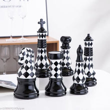 Load image into Gallery viewer, Checkered 6-piece Chess Set by Allthingscurated is both elegant and delightfully unique. Designed with a striking, graphic pattern in black and white, it adds a touch of sophistication to any space, whether your home décor style is modern or traditional. Made of porcelain, this decorative set is an ideal gift for any chess lovers.