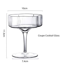 Load image into Gallery viewer, Florentina Drinkware by Allthingscurated embraces a modern design featuring sleek fluted lines with a unique shape reminiscent of a peach blossom flower. Stylish and chic, this collection includes a carafe, goblets and several tumblers, including a glamorous coupe cocktail glass. Add elegance to everyday use with this beautiful collection and just as perfect for setting an extravagant holiday table. Seen here is a Coupe Cocktail Glass.