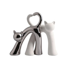 Load image into Gallery viewer, These Cat Couple Love Figurines by Allthingscurated are perfect for cat lovers. Made of ceramic, they feature a pair of cute and whimsical cats in contrasting colors, with their tails entwined to form a heart shape. A romantic and unique gift for any occasion.