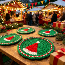 Load image into Gallery viewer, Red, green and white Santa Hat design crochet coasters laid on a wooden bench, with a gift and some Christmas decorations. Background shows a Christmas carnival with people merry making.