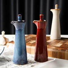 Load image into Gallery viewer, Japanese Style Ceramic Oil Vinegar Cruet by Allthingscurated is crafted from kiln-fired glazed porcelain with a glossy and smooth finish. Spots a tapered, elegant silhouette, it is perfect for storing and serving condiments from soy sauce and sesame oil, to olive oil and vingegar. Comes in 5 beautiful colors.