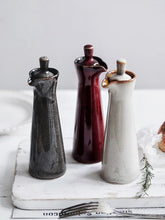 Load image into Gallery viewer, Japanese Style Ceramic Oil Vinegar Cruet by Allthingscurated is crafted from kiln-fired glazed porcelain with a glossy and smooth finish. Spots a tapered, elegant silhouette, it is perfect for storing and serving condiments from soy sauce and sesame oil, to olive oil and vingegar. Comes in 5 beautiful colors.