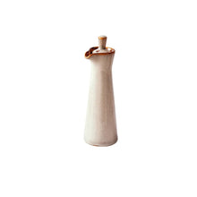 Load image into Gallery viewer, Japanese Style Ceramic Oil Vinegar Cruet by Allthingscurated is crafted from kiln-fired glazed porcelain with a glossy and smooth finish. Spots a tapered, elegant silhouette, it is perfect for storing and serving condiments from soy sauce and sesame oil, to olive oil and vingegar. Comes in 5 beautiful colors. Featured here is bottle in Sand.