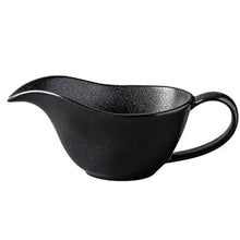 Load image into Gallery viewer, Curtis Ceramic Gravy Boat by Allthingscurated features an easy-to-hold handle and a narrow spout to ensure precise pouring without spills and drips. Available in white with a smooth, shiny glaze or black with a matte, rough finish. This versatile serveware with a capacity of 220ml or 7.4 fluid ounce is perfect for any occasion, formal or casual. Featured here is the black gravy boat with a matte, rough finish.