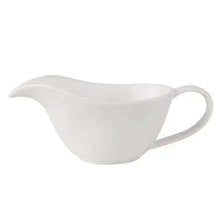 Load image into Gallery viewer, Curtis Ceramic Gravy Boat by Allthingscurated features an easy-to-hold handle and a narrow spout to ensure precise pouring without spills and drips. Available in white with a smooth, shiny glaze or black with a matte, rough finish. This versatile serveware with a capacity of 220ml or 7.4 fluid ounce is perfect for any occasion, formal or casual. Featured here is the white gravy boat in shiny, smooth glazed finish.