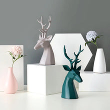 Load image into Gallery viewer, This beautiful Deer Head Bust sculpture is made of resin and comes available in 4 colors of black, white, gray and teal. Measuring 26cm or 10 inches in height and 11.5cm or 4.5 inches in width. This figurine spots a contemporary design with sculptural form inspired by Origami. This decorative piece will add timeless elegance to your space year-round. Perfect for festive tablescapes, mantels and shelves.