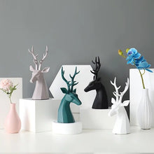 Load image into Gallery viewer, This beautiful Deer Head Bust sculpture is made of resin and comes available in 4 colors of black, white, gray and teal. Measuring 26cm or 10 inches in height and 11.5cm or 4.5 inches in width. This figurine spots a contemporary design with sculptural form inspired by Origami. This decorative piece will add timeless elegance to your space year-round. Perfect for festive tablescapes, mantels and shelves.