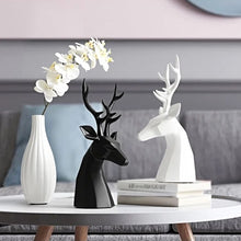 Load image into Gallery viewer, This beautiful Deer Head Bust sculpture is made of resin and comes available in 4 colors of black, white, gray and teal. Measuring 26cm or 10 inches in height and 11.5cm or 4.5 inches in width. This figurine spots a contemporary design with sculptural form inspired by Origami. This decorative piece will add timeless elegance to your space year-round. Perfect for festive tablescapes, mantels and shelves.