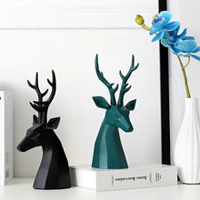Load image into Gallery viewer, This beautiful Deer Head Bust sculpture is made of resin and comes available in 4 colors of black, white, gray and teal. Measuring 26cm or 10 inches in height and 11.5cm or 4.5 inches in width. This figurine spots a contemporary design with sculptural form inspired by Origami. This decorative piece will add timeless elegance to your space year-round. Perfect for festive tablescapes, mantels and shelves.