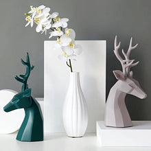 Load image into Gallery viewer, This beautiful Deer Head Bust sculpture is made of resin and comes available in 4 colors of black, white, gray and teal. Measuring 26cm or 10 inches in height and 11.5cm or 4.5 inches in width. This figurine spots a contemporary design with sculptural form inspired by Origami. This decorative piece will add timeless elegance to your space year-round. Perfect for festive tablescapes, mantels and shelves.