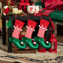 Load image into Gallery viewer, Holiday Elf Stocking by Allthingscurated are inspired by the signature curly-toed boots and striped tights that are worn by the little elves. The cute design is both fun and bright in traditional Christmas red and green. They are perfect for adding some jolly cheer to your holiday décor.