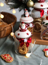 Load image into Gallery viewer, Christmas Festive Storage Jars by Allthingscurated are the perfect jars to keep all your festive treats fresh and delicious. The jars are airtight and each jar is topped with a ceramic lid decorated with a Santa Claus, Christmas Tree, Penguin, Gnome or Fox. Comes in 2 sizes with capacity of 300ml or 10 ounce and 1000ml or 34 ounce.