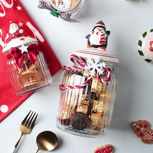 Load image into Gallery viewer, Christmas Festive Storage Jars by Allthingscurated are the perfect jars to keep all your festive treats fresh and delicious. The jars are airtight and each jar is topped with a ceramic lid decorated with a Santa Claus, Christmas Tree, Penguin, Gnome or Fox. Comes in 2 sizes with capacity of 300ml or 10 ounce and 1000ml or 34 ounce.