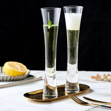 Load image into Gallery viewer, Combining style and functionality, Fion Champagne Flutes by Allthingscurated are hand-crafted from 100% lead-free crystal glass. These elegant flutes boast a sleek, modern, minimalistic design with a weighty base to provide stability and helps to maintain the temperature of your champagne. Comes in a set of 2 or 4 glasses. They are perfect for special occasion and make a stunning wedding gift.