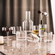 Load image into Gallery viewer, Florentina Drinkware by Allthingscurated embraces a modern design featuring sleek fluted lines with a unique shape reminiscent of a peach blossom flower. Stylish and chic, this collection includes a carafe, goblets and several tumblers, including a glamorous coupe cocktail glass. Add elegance to everyday use with this beautiful collection and just as perfect for setting an extravagant holiday table.
