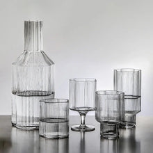 Load image into Gallery viewer, Florentina Drinkware by Allthingscurated embraces a modern design featuring sleek fluted lines with a unique shape reminiscent of a peach blossom flower. Stylish and chic, this collection includes a carafe, goblets and several tumblers, including a glamorous coupe cocktail glass. Add elegance to everyday use with this beautiful collection and just as perfect for setting an extravagant holiday table.