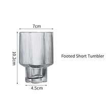 Load image into Gallery viewer, Florentina Drinkware by Allthingscurated embraces a modern design featuring sleek fluted lines with a unique shape reminiscent of a peach blossom flower. Stylish and chic, this collection includes a carafe, goblets and several tumblers, including a glamorous coupe cocktail glass. Add elegance to everyday use with this beautiful collection and just as perfect for setting an extravagant holiday table. Seen here is a Footed Short Tumbler.