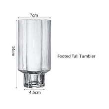 Load image into Gallery viewer, Florentina Drinkware by Allthingscurated embraces a modern design featuring sleek fluted lines with a unique shape reminiscent of a peach blossom flower. Stylish and chic, this collection includes a carafe, goblets and several tumblers, including a glamorous coupe cocktail glass. Add elegance to everyday use with this beautiful collection and just as perfect for setting an extravagant holiday table. Seen here is a Footed Tall Tumbler.