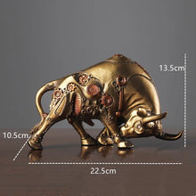 Load image into Gallery viewer, Futurox bull sculpture by Allthingscurated is the embodiment of steampunk aesthetics and futuristic mechanics. This exquisite masterpiece combines the grace and strength of a bull with the intricate beauty of gears. Standing at a height of 13.5cm or 5.3 inches, with length of 22.5cm or 8.8 inches and depth of 10.5cm or 4.1 inches. Its captivating presence will effortlessly elevate any space. Comes in gold and silver. Featured here the sculpture in Gold.