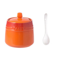 Load image into Gallery viewer, Gradient Colored Seasonings Jar by Allthingscurated come equipped with spoons for convenient access to their contents during cooking and dining. Made from high-quality porcelain, their vibrant colors in gradient tones and stylish design will add a pop of color to your kitchen or dining table, while keeping your herbs, spices and seasonings neatly stored and organized. 8 tasty colors to choose from. Featured here is jar in orange.